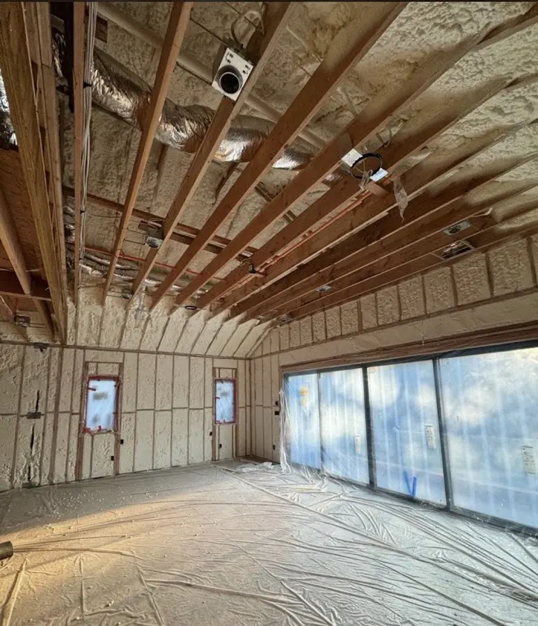 Interior walls and ceiling insulated with spray foam during new construction in Inverness